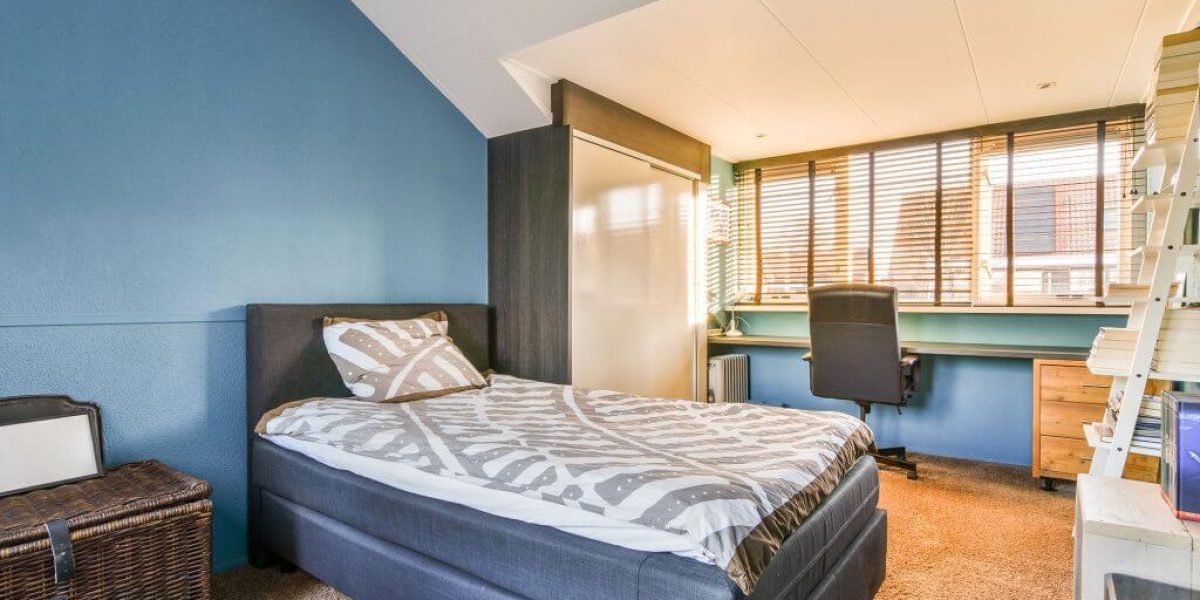 a-bedroom-with-a-bed-and-a-desk-and-window-2023-04-11-01-10-42-utc-1024x682
